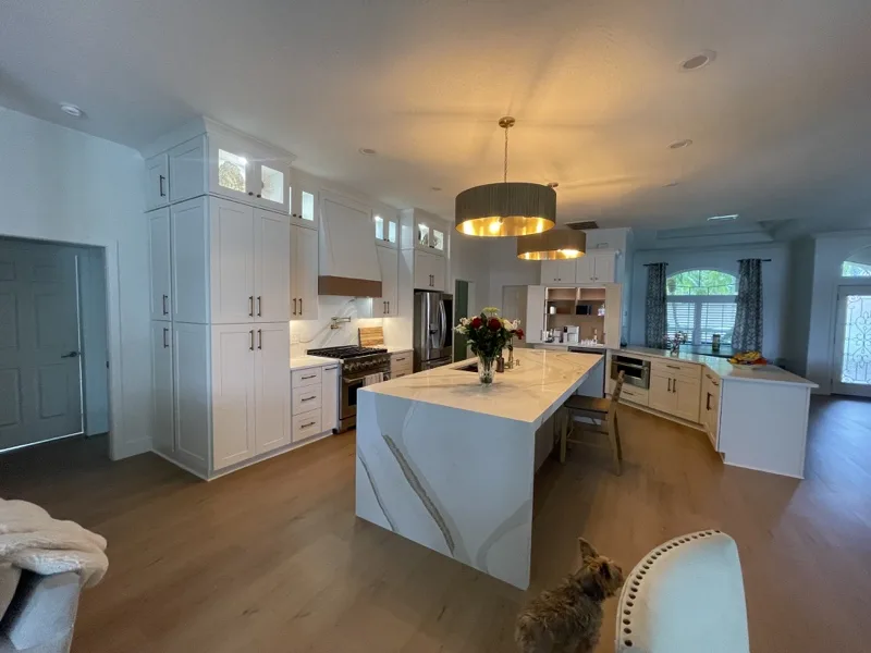 Custom kitchen island with a waterfall stone edge, built and installed by Piloni Home Design